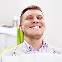 Smiling man sitting in dental office 