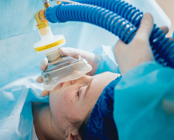 Anesthesia mask being placed on patient’s face